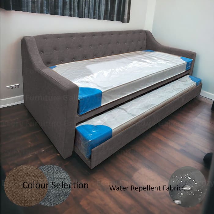 A grey 3 in 1 bed with a tufted button backrest in a room with wooden flooring and windows. The pull out bed is upholstered by water-repellent fabric