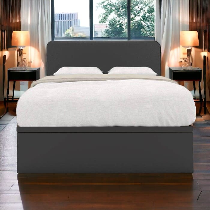 Storage Bed Singapore - a storage bed frame with white sheets on a dark wooden floor, with a modern bedroom in the backgroud