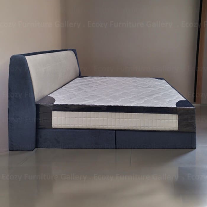 The side view of a modern divan bed frame with the plain and wingback design headboard. The bed is upholstered by water-repellent fabric, with 2 color combination