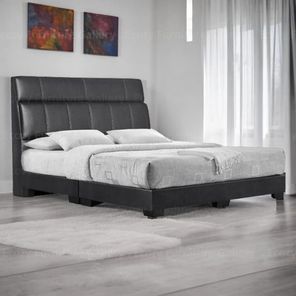 A modern divan bed upholstered in black color faux leather, it is features a sleek design with a cushioned headboard