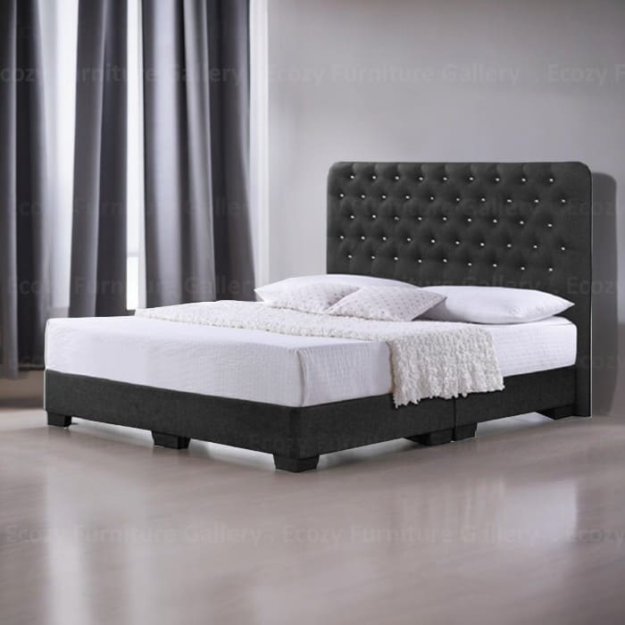 A black upholstered bed frame with a slightly curved, tufted crystal headboard and black legs