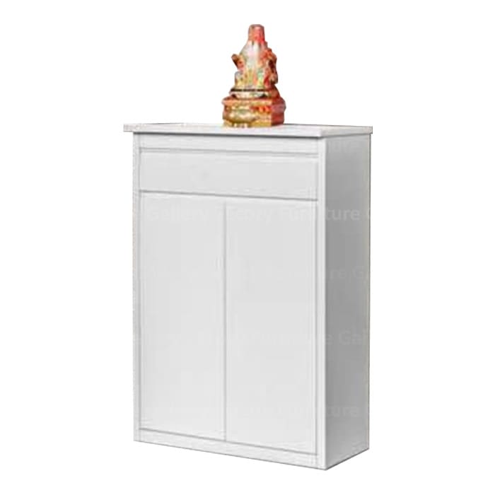 White wooden altar cabinet featuring a statue, styled with decorative items on the table top