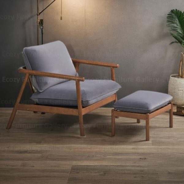 wooden arm chair with a grey fabric cushion, featuring wooden armrests and a sleek design, set in a cozy living room with warm lighting and wooden flooring