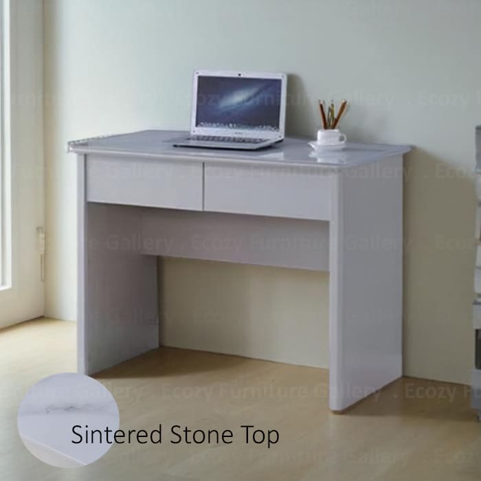 study desk or computer table featuring a sintered stone table top,and a sleek design, set in a cozy living room with warm lighting and wooden flooring