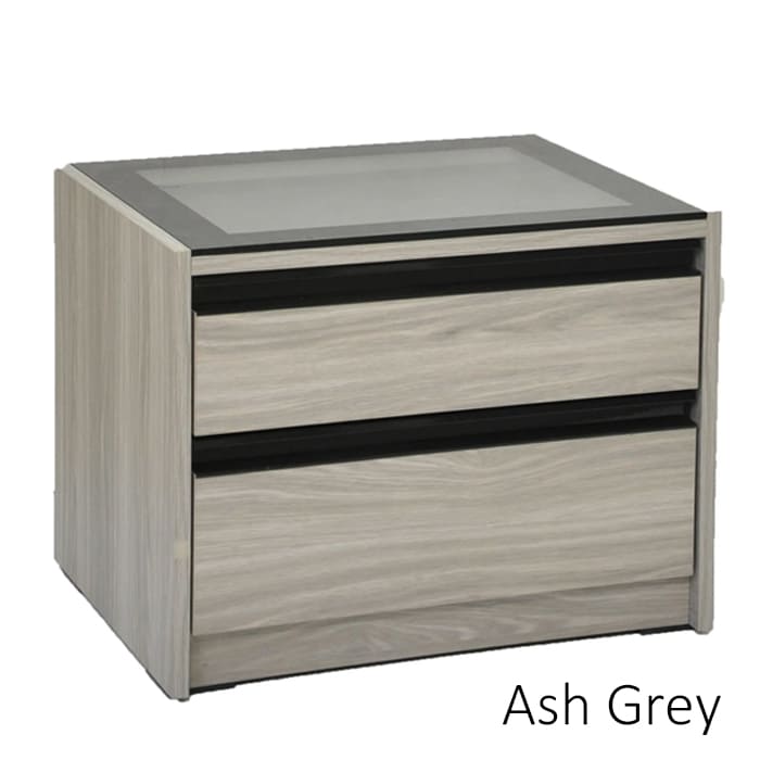 Bed side table with a wood finish, featuring two drawers with metal handle, styled with decorative items on top