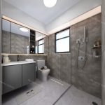 modern bathroom renovation with gray tiles, a sleek vanity, large mirrors, a shower area, and natural light from windows