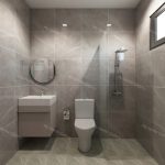 modern bathroom renovation with gray tiles, a sleek vanity, small mirrors, a shower area, and natural light from windows