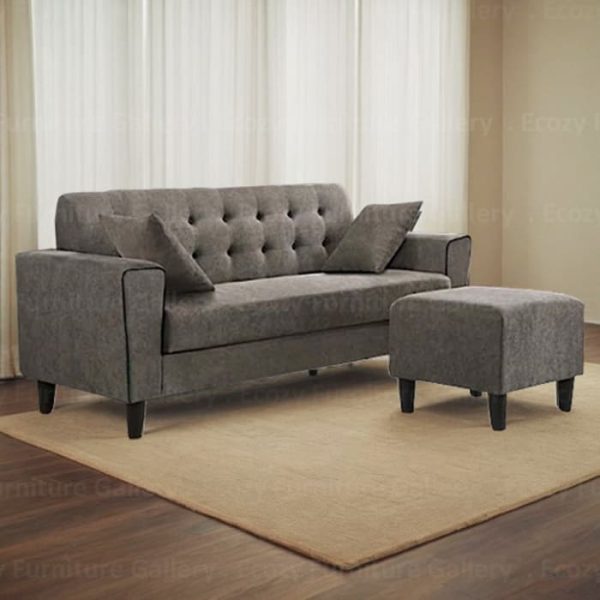 A sleek brown fabric sofa Singapore, complete with two throw cushions and a matching ottoman, perfect for modern living spaces